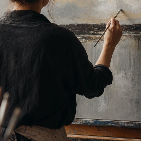Artist applying final brushstrokes to canvas — detail